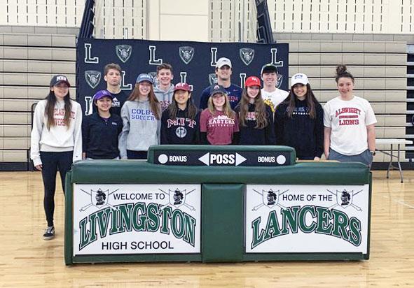 student athletes pose for a photo on college commitment day